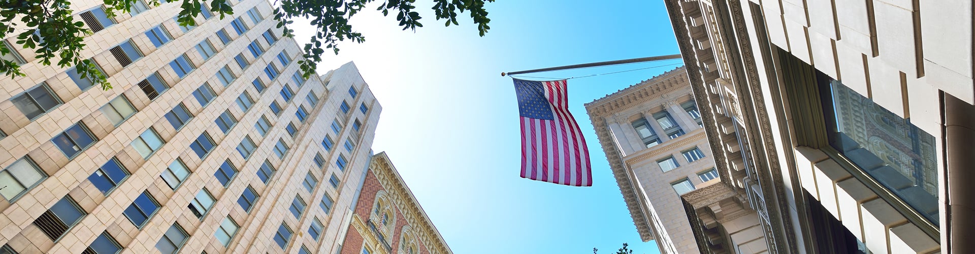 Government buildings with US flag on sunny day