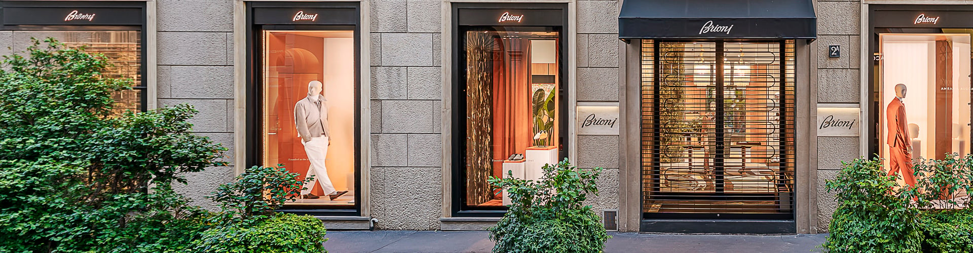 Luxury grey-brick shopfront with mannequins in the windows