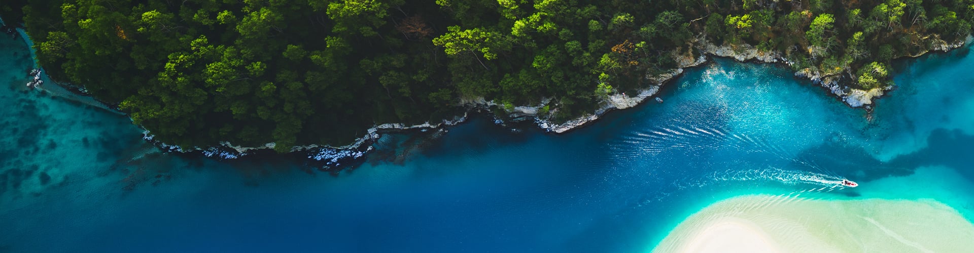 Aerial view of boat in clear blue sea water