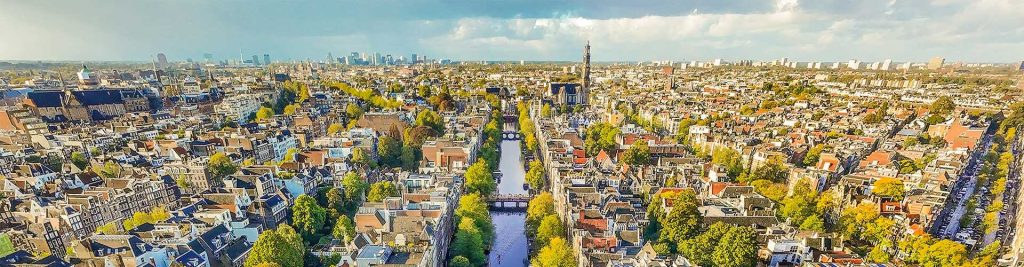 Aerial view of the buildings, water and bridges in Amsterdam on a sunny day