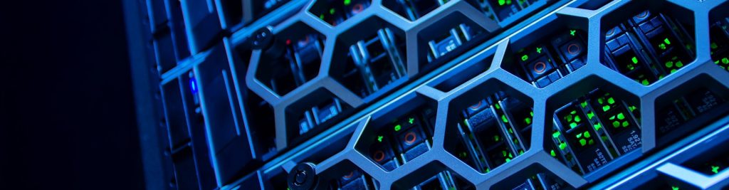 Close-up of a data center server rack with hexagonal metal grilles